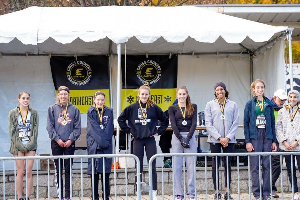 Zariel Macchia (second from right) stands with other top finishers at the Eastbay Cross Country Regional Championships.