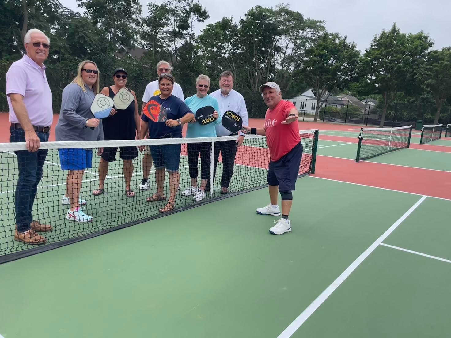 The newly redone courts today. Pictured is trustee Joseph Keyes, BID executive director Dennis Smith and Parks and Rec director Maria Giustizia with the pickleball players.